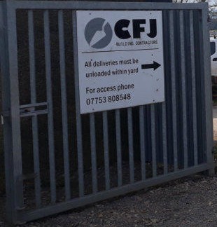 The CFJ Building Contractors sign on the yard gate at Lower Powburn